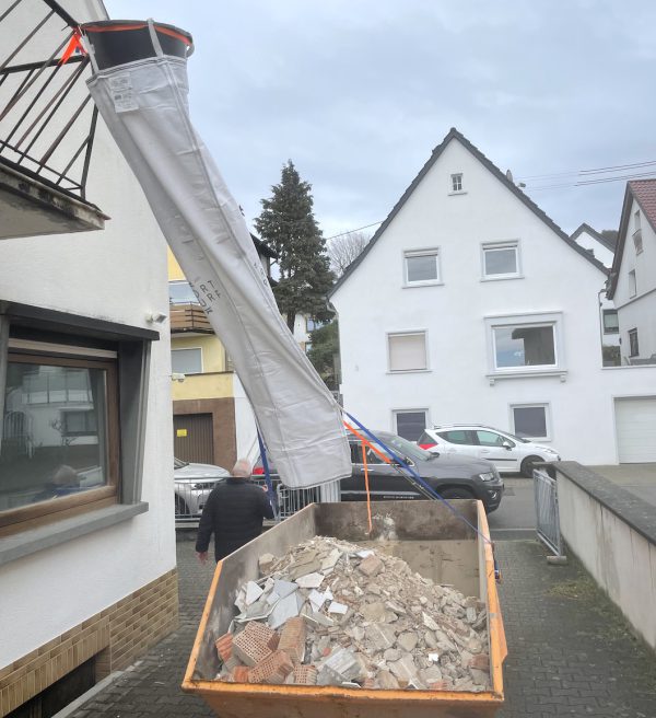 Flexible debris chute during roof repair