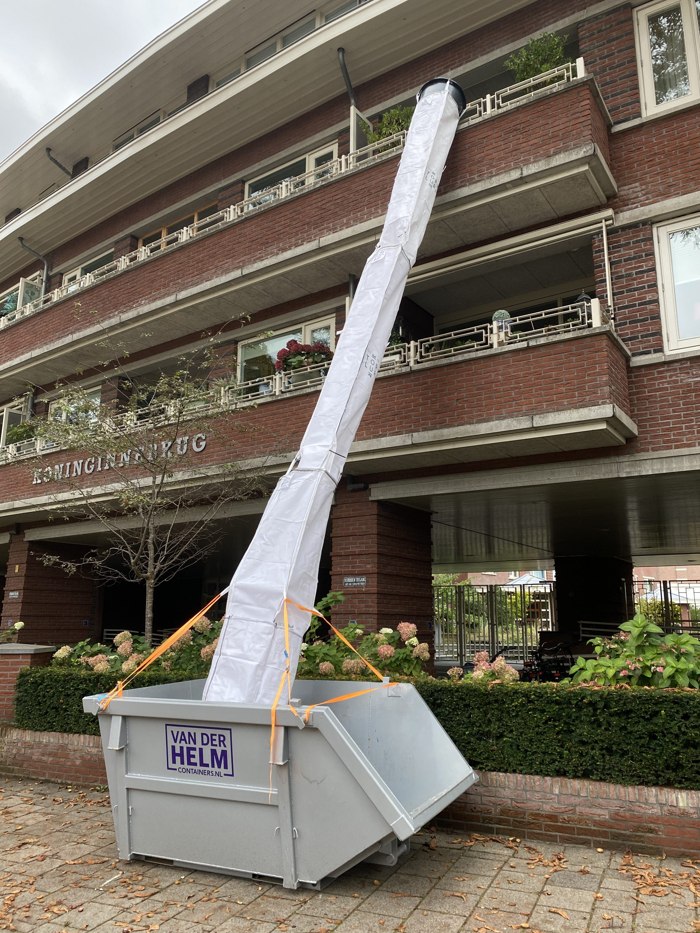 Flexible rubble chute in use during a renovation